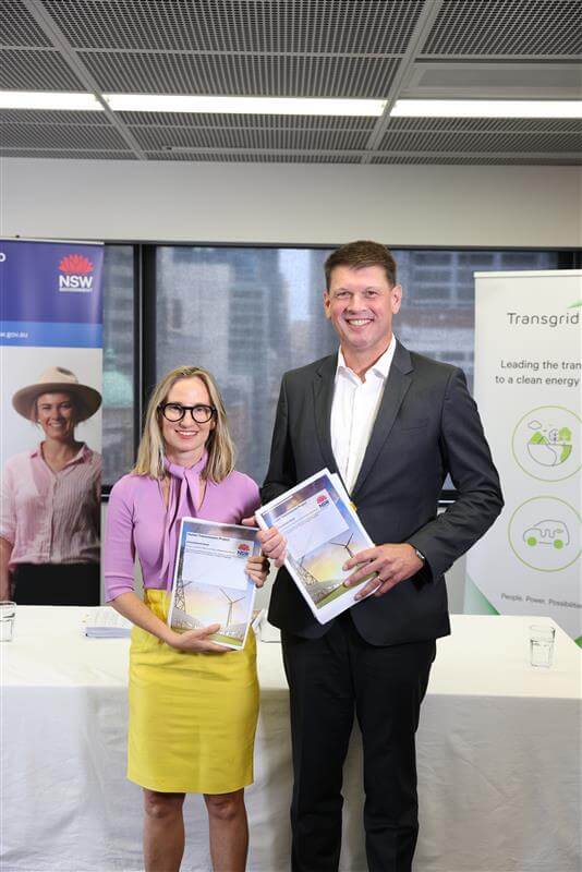 Female and Male standing next to each other holding certificates