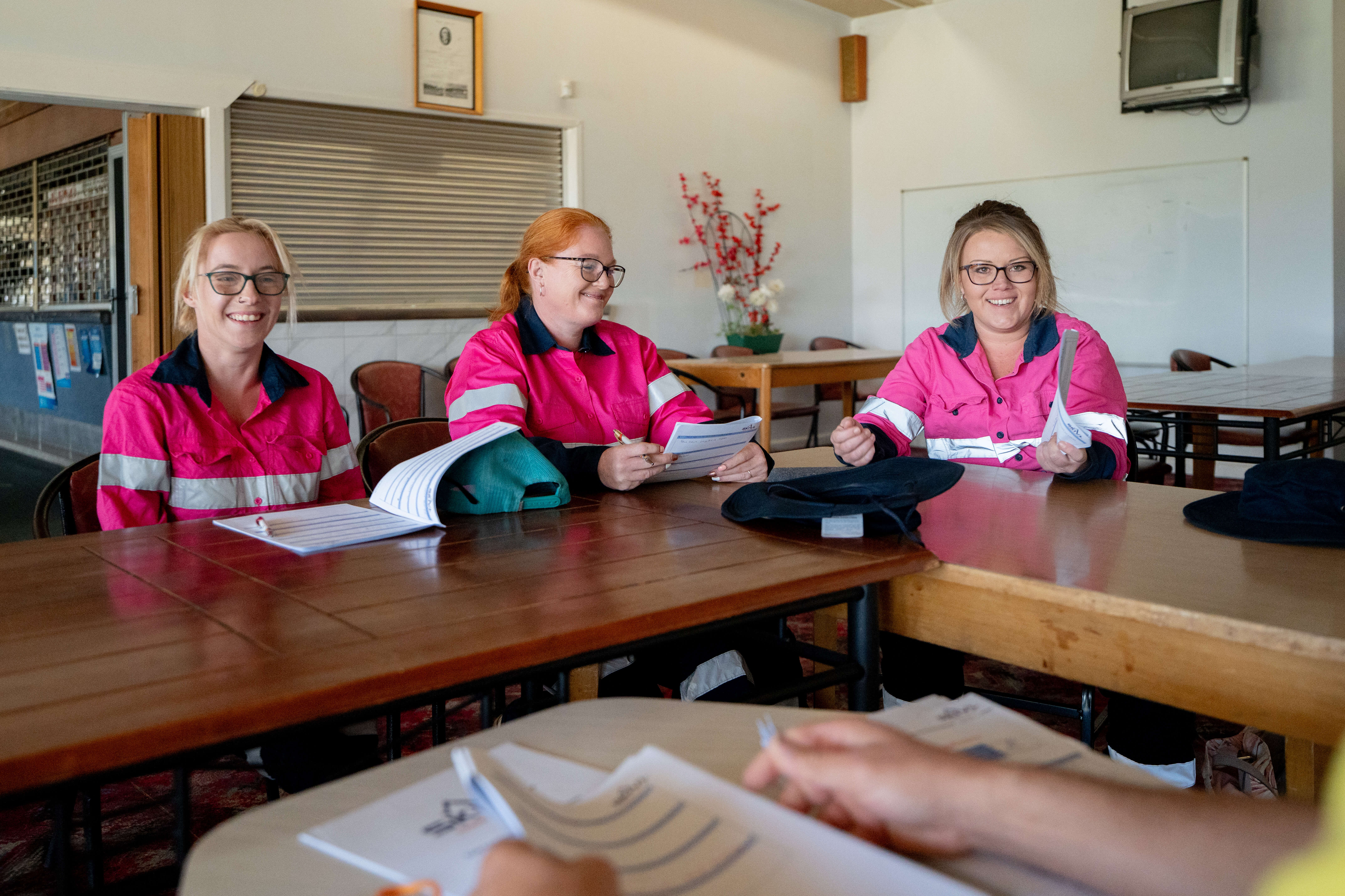 Image of three women in a classroom learning